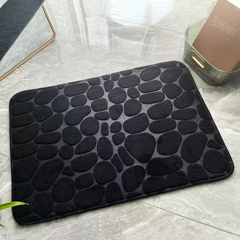 Black textured bath mat on a bathroom floor