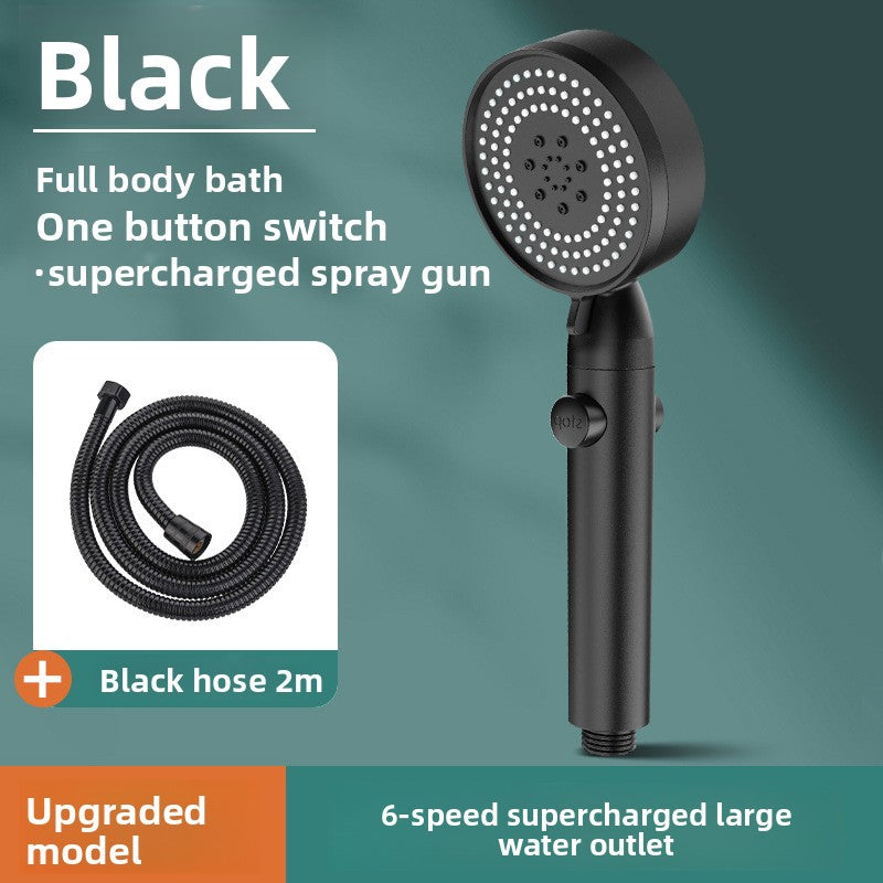 Black handheld shower head with hose on a green background