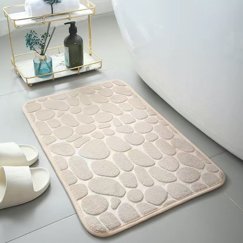 Champagne textured bath mat on a bathroom floor