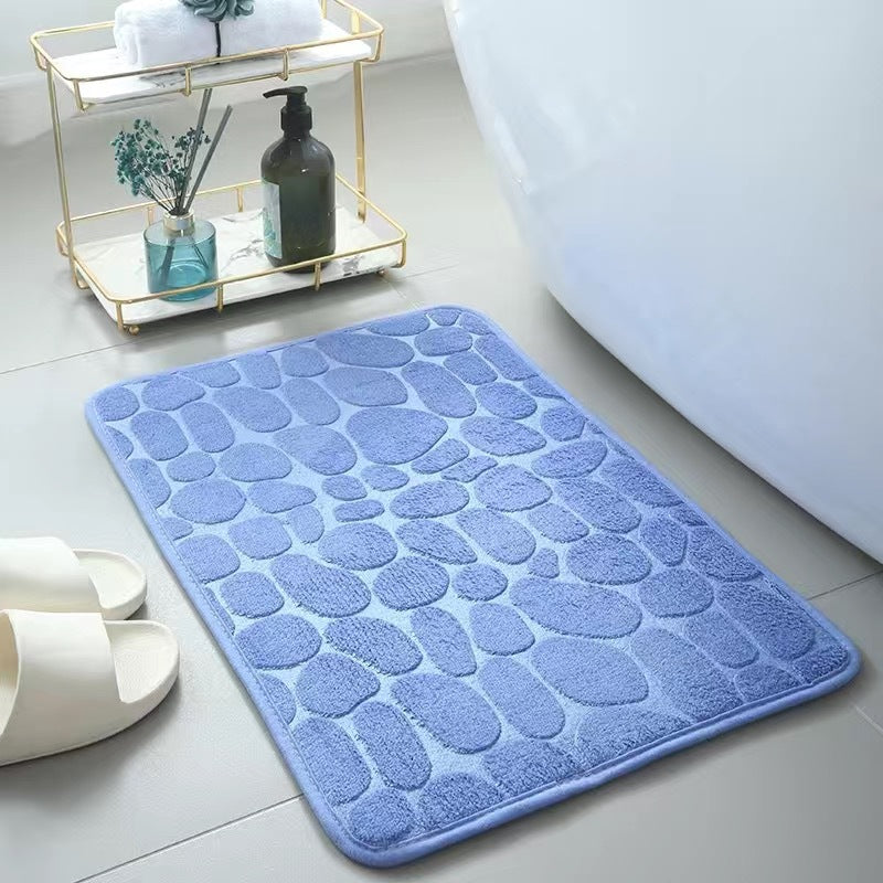 Light Blue textured bath mat on a bathroom floor