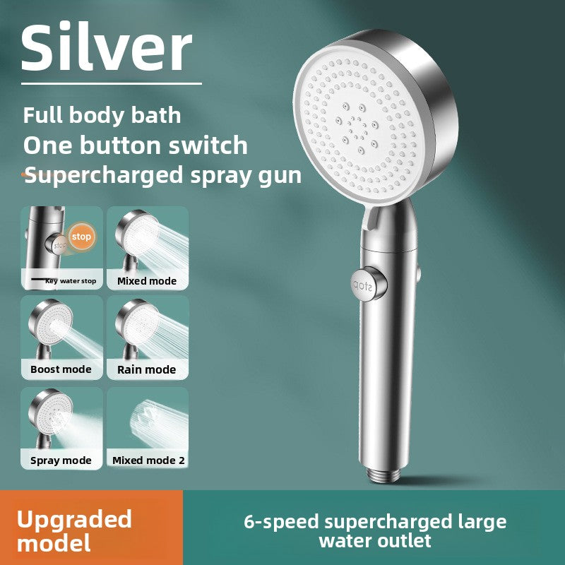 Silver handheld shower head with features listed on a green background